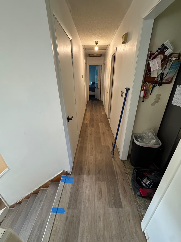 Laminate plank flooring installed along a hallway