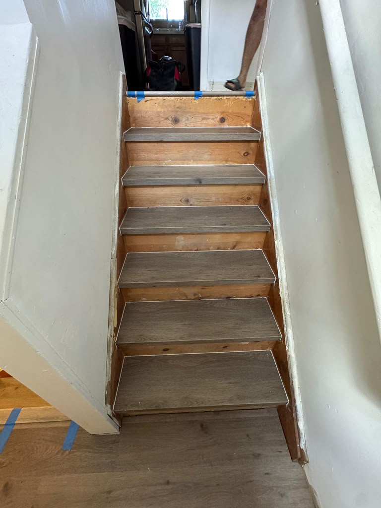 Laminate stair tread installation in progress