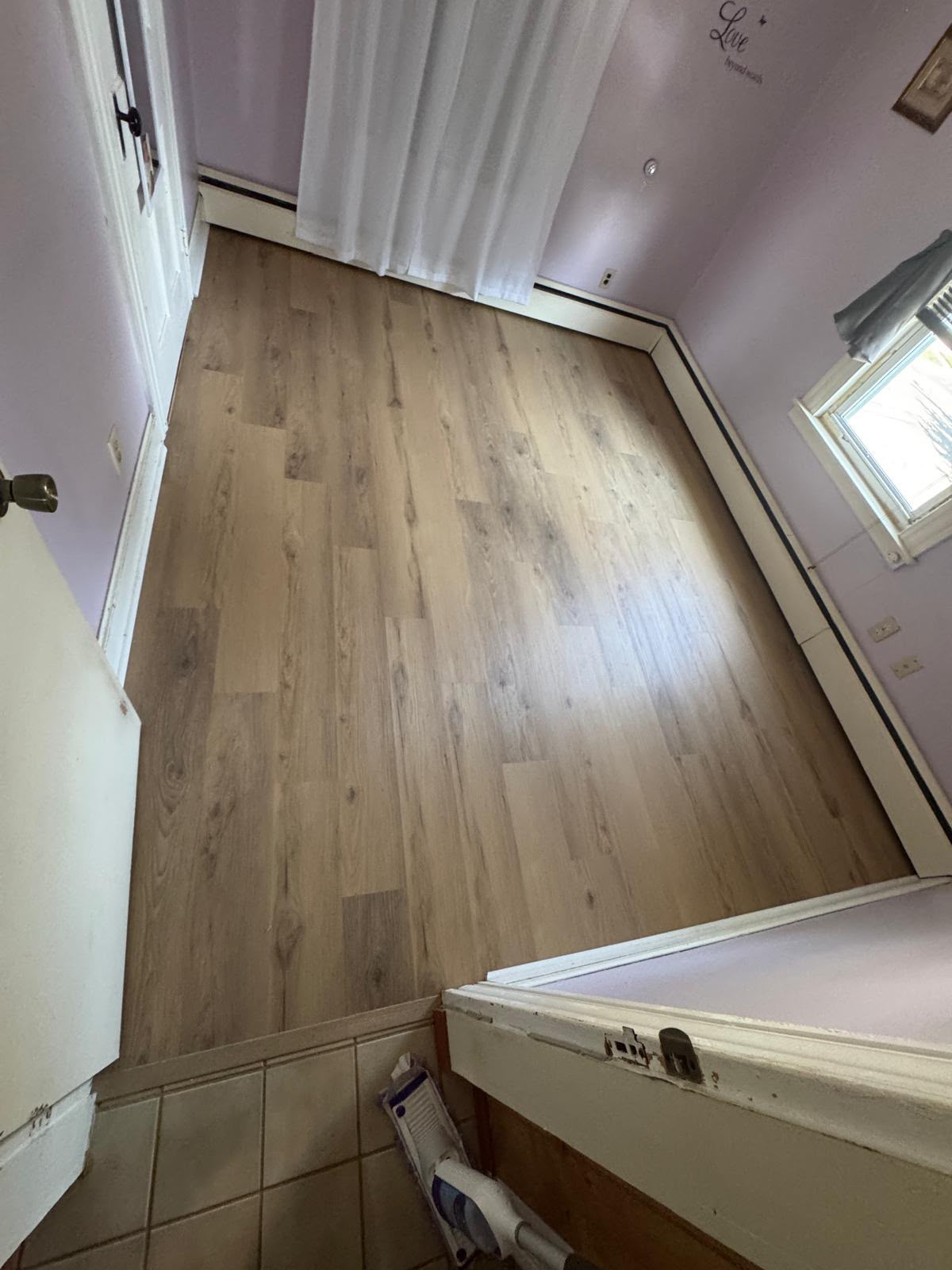 Laminate flooring installed in a small bathroom and laundry area