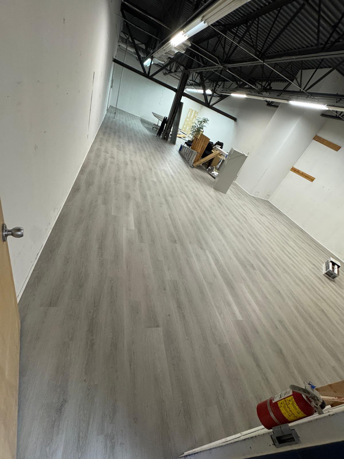 Commercial vinyl plank flooring installation in a large open space