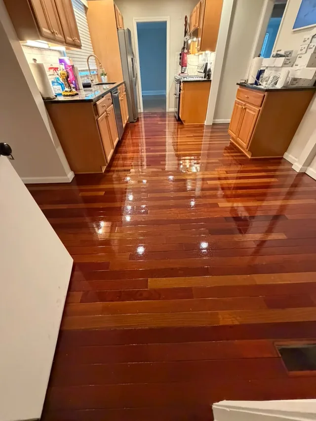 Deep red hardwood with a high-gloss finish through a kitchen