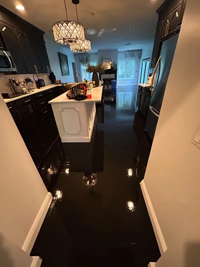 Ebony high-gloss floor in a kitchen with an island