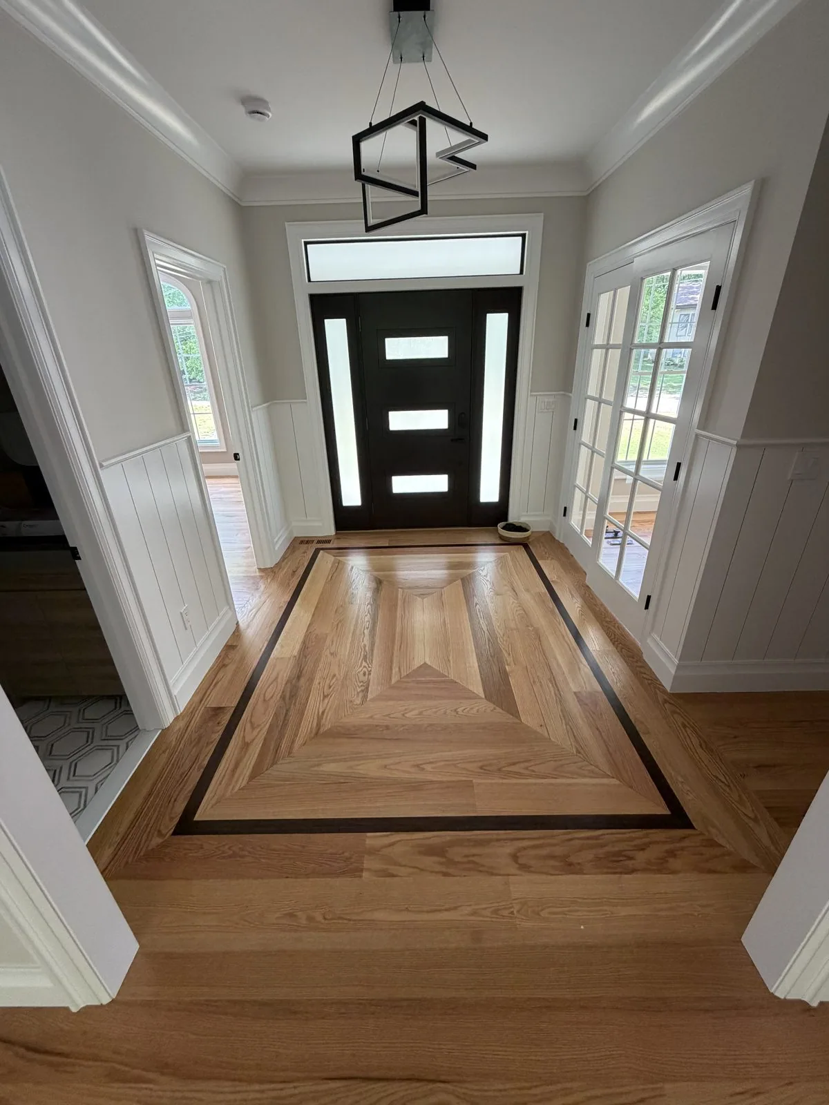 Entryway with a custom inlaid hardwood border