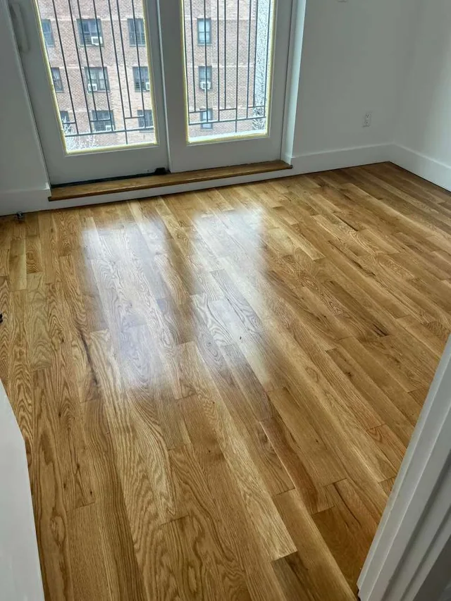 Refinished natural oak floor by French doors