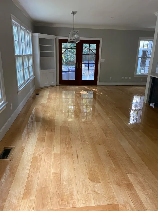 Refinished natural oak with a gloss finish in a room with French doors