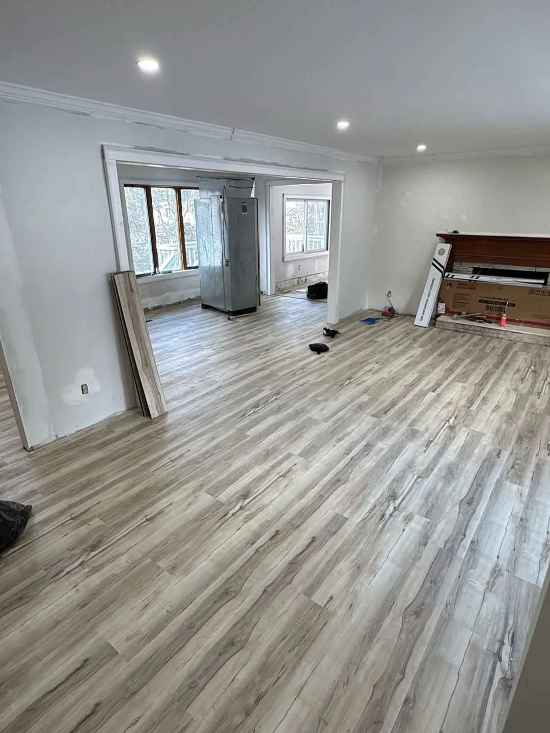 Gray vinyl plank flooring installed in an open room