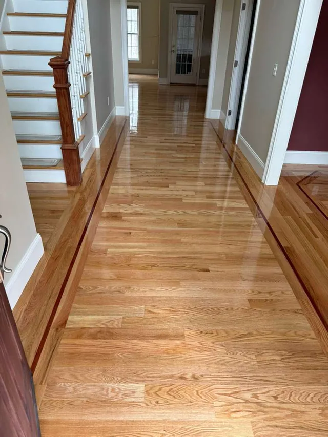 Hallway with a contrasting border strip along the stairs