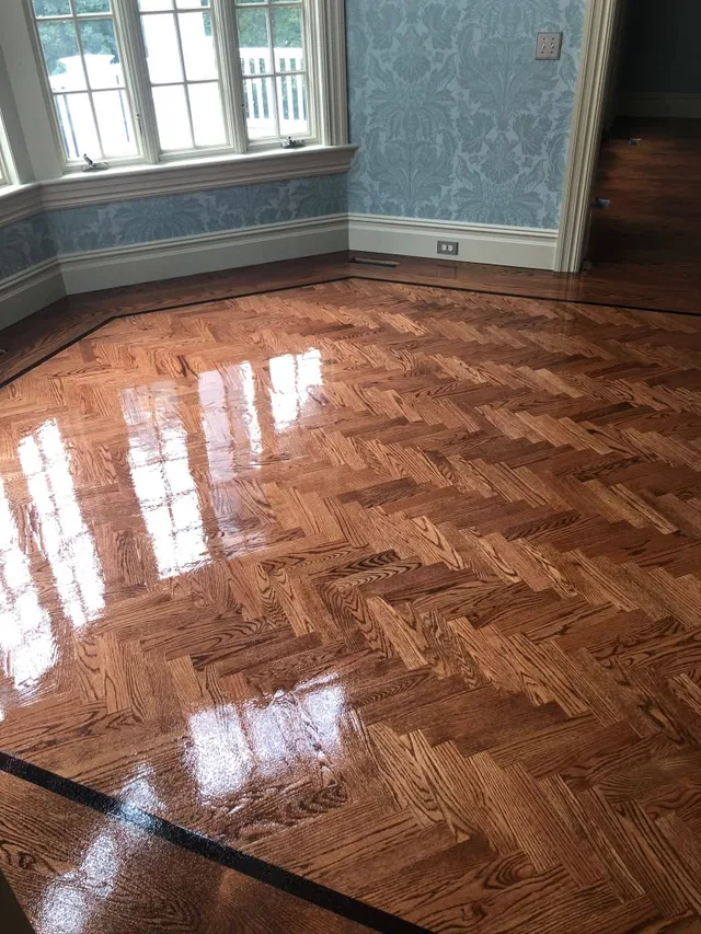 Herringbone floor refinished in high gloss with a black border
