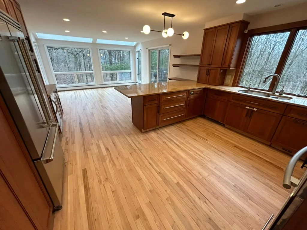 New natural oak floor in an open kitchen with wood cabinets