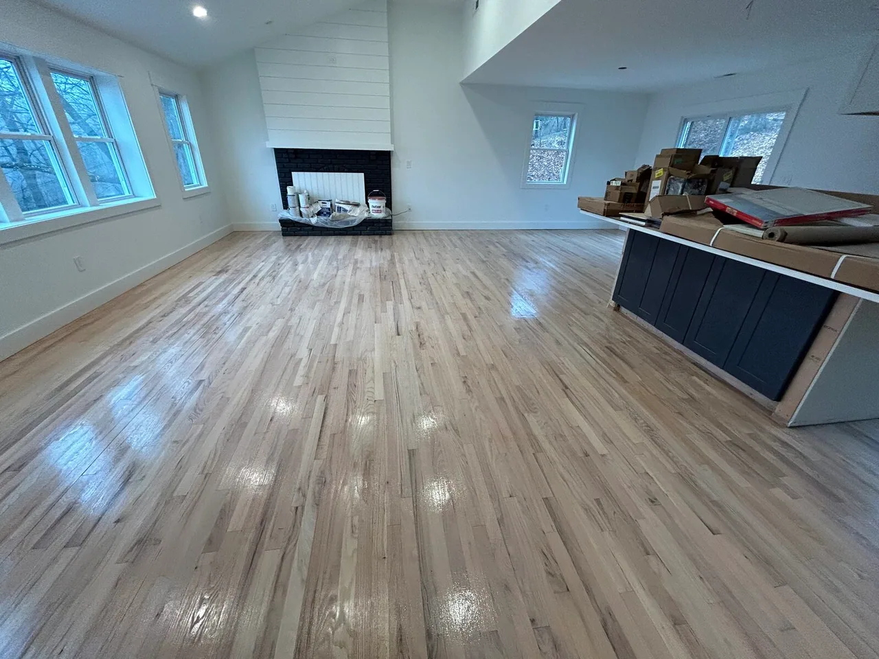 Refinished light hardwood in an open-plan living room