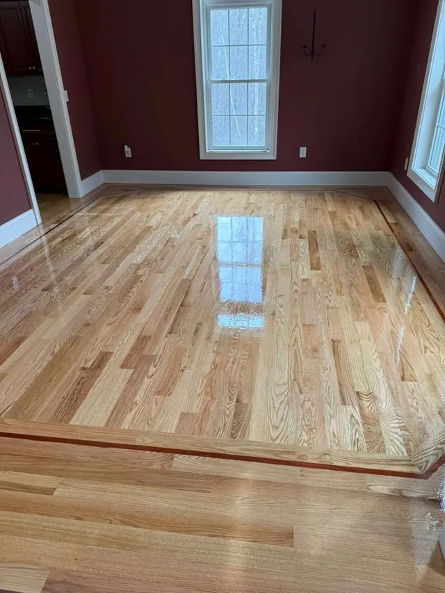 Natural oak with a border in a room with red walls