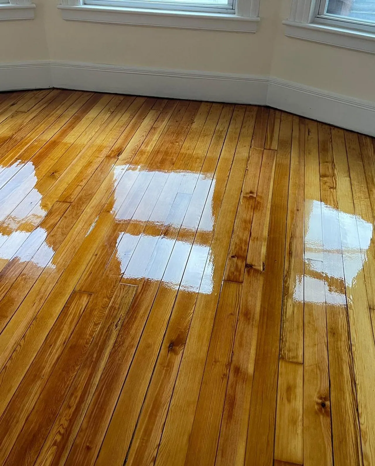 Wide-plank pine floor with a high-gloss finish